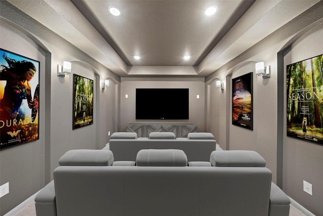 home theater with a tray ceiling, carpet flooring, baseboards, and recessed lighting