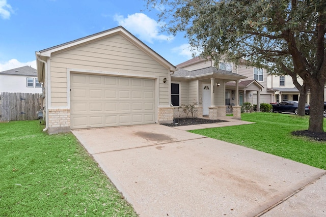 view of front of home with a garage, a front yard, fence, and brick siding