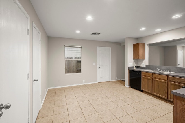 kitchen with black dishwasher, dark countertops, visible vents, brown cabinetry, and a sink