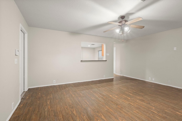 unfurnished room featuring wood finished floors, a ceiling fan, and baseboards