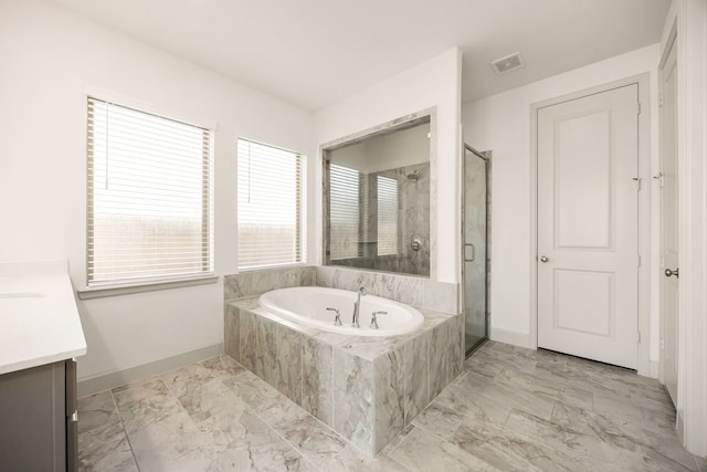 bathroom with a stall shower, visible vents, a garden tub, marble finish floor, and vanity