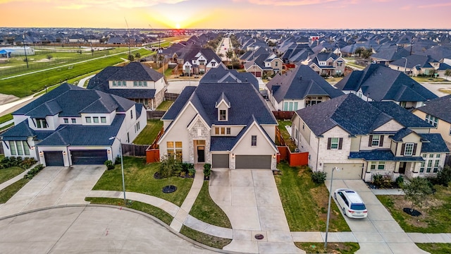 aerial view at dusk featuring a residential view