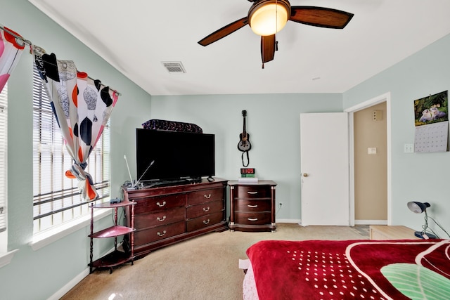 bedroom with ceiling fan, carpet flooring, visible vents, and baseboards