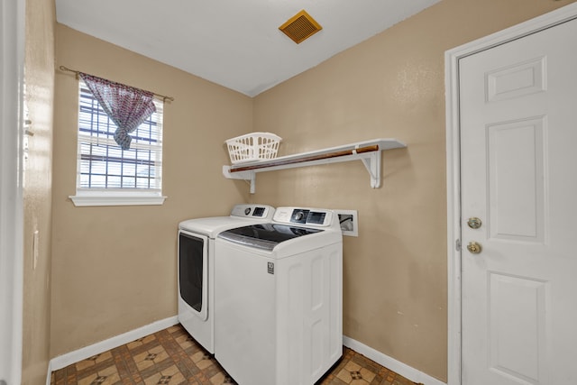 laundry room featuring laundry area, baseboards, visible vents, and washing machine and clothes dryer