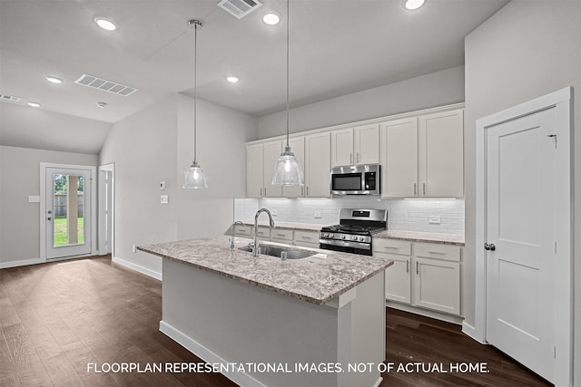 kitchen with stainless steel appliances, a sink, visible vents, and decorative backsplash