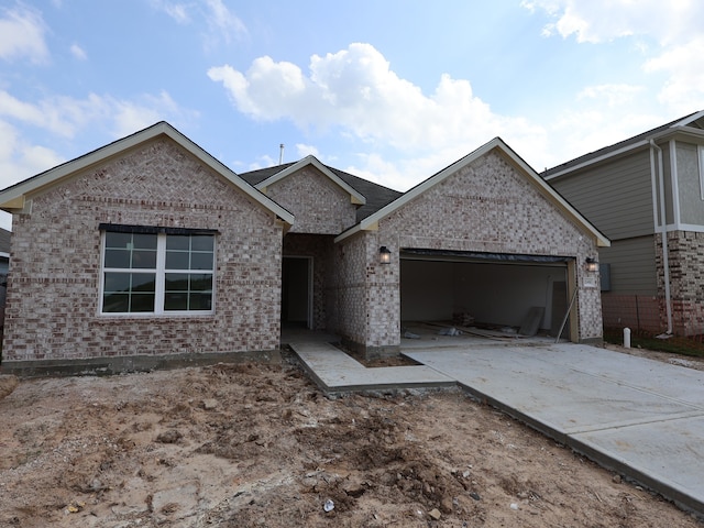 ranch-style house with an attached garage, brick siding, and driveway