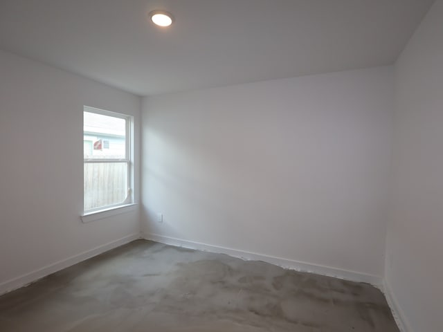 spare room featuring baseboards