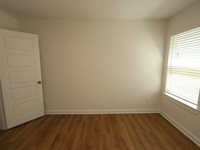 22450 Birchfield Grove Ln, New Caney, TX 77357 - empty room featuring dark wood-style floors and baseboards