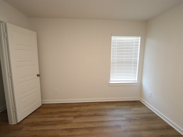 22450 Birchfield Grove Ln, New Caney, TX 77357 - spare room with dark wood finished floors, plenty of natural light, and baseboards
