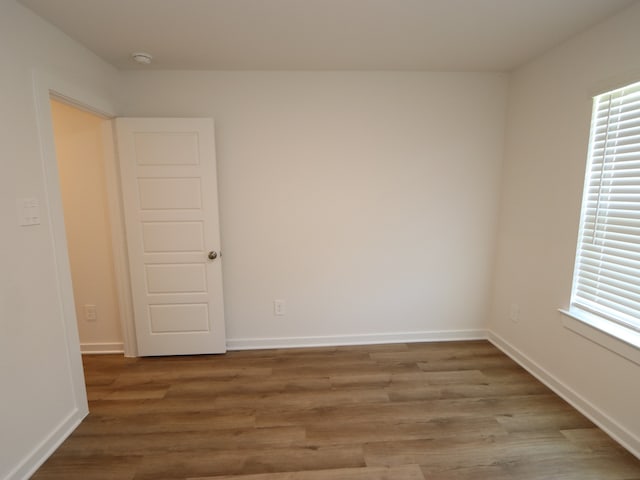 22450 Birchfield Grove Ln, New Caney, TX 77357 - unfurnished room featuring wood finished floors, a smoke detector, and baseboards