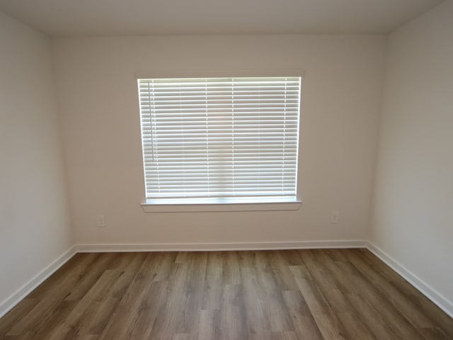 22450 Birchfield Grove Ln, New Caney, TX 77357 - unfurnished room featuring wood finished floors and baseboards