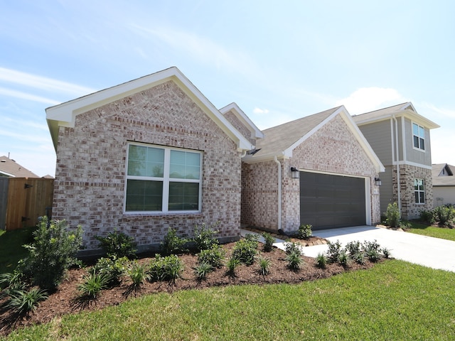 22450 Birchfield Grove Ln, New Caney, TX 77357 - view of front of home with brick siding, concrete driveway, and a garage