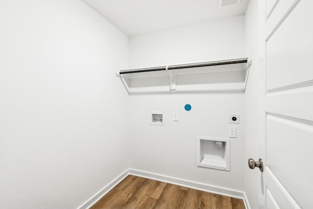 22450 Birchfield Grove Ln, New Caney, TX 77357 - washroom featuring hookup for an electric dryer, wood finished floors, hookup for a washing machine, and gas dryer hookup
