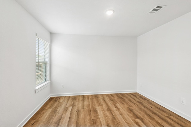 22450 Birchfield Grove Ln, New Caney, TX 77357 - spare room featuring light wood-style flooring and baseboards