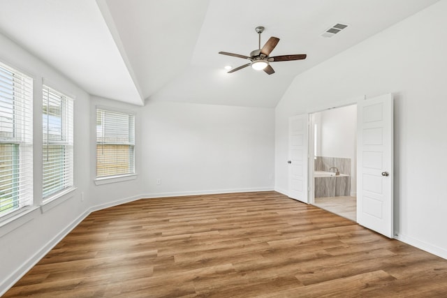 22450 Birchfield Grove Ln, New Caney, TX 77357 - unfurnished bedroom with lofted ceiling, wood finished floors, connected bathroom, and a ceiling fan