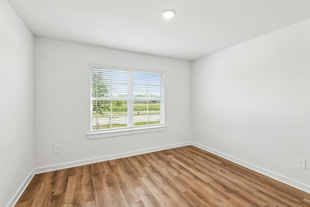 22450 Birchfield Grove Ln, New Caney, TX 77357 - empty room featuring wood finished floors and baseboards