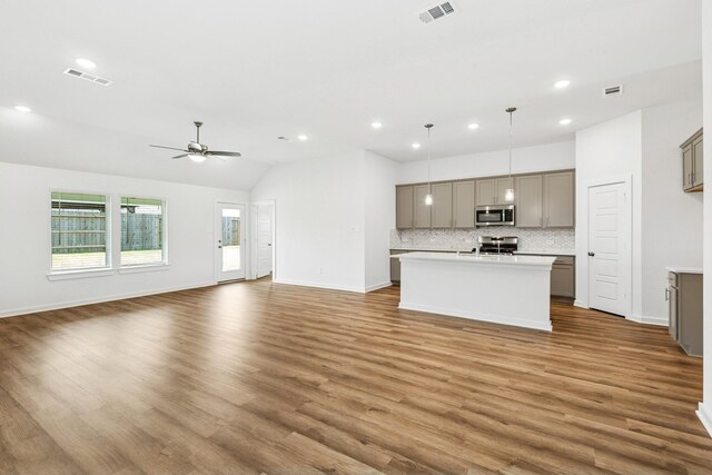 22450 Birchfield Grove Ln, New Caney, TX 77357 - unfurnished living room featuring ceiling fan, wood finished floors, recessed lighting, and lofted ceiling