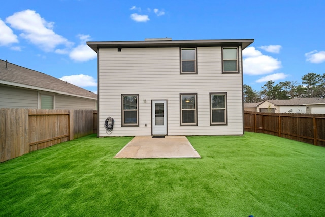 back of property with a yard, a patio area, and a fenced backyard