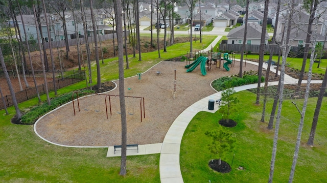 communal playground with a residential view, a lawn, and fence