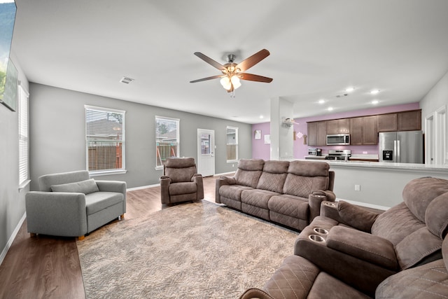 living room featuring recessed lighting, visible vents, a ceiling fan, wood finished floors, and baseboards
