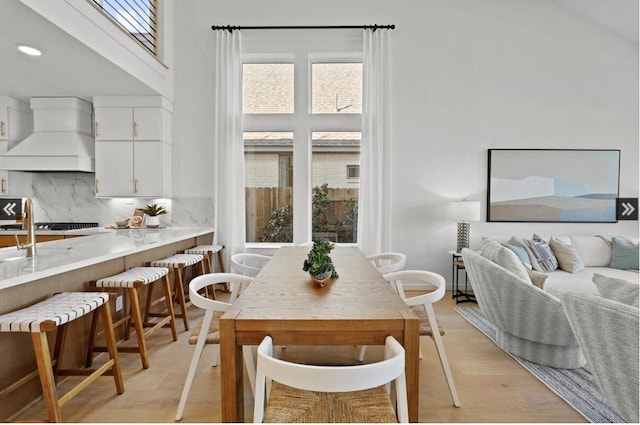 dining room featuring light wood-type flooring and recessed lighting