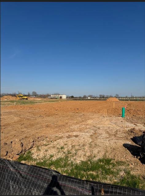 view of yard featuring a rural view and fence