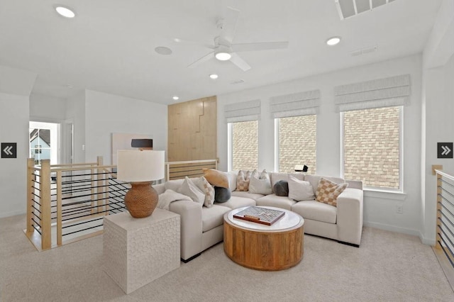 living area with light colored carpet, a ceiling fan, recessed lighting, and baseboards