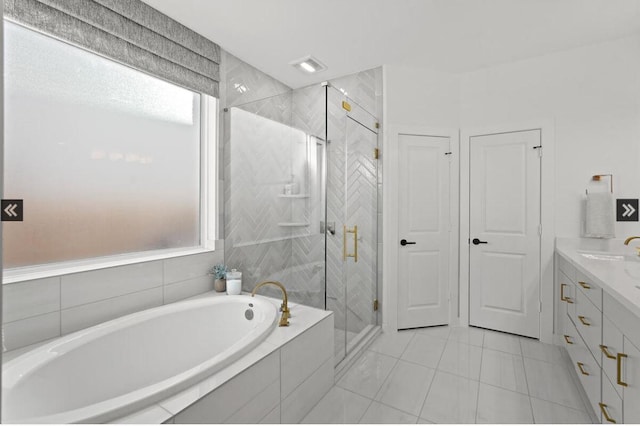 bathroom with a garden tub, tile patterned flooring, a shower stall, and vanity