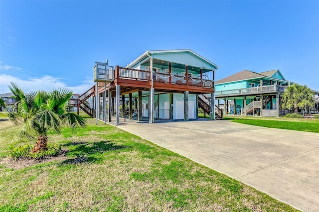 view of front of property featuring a carport, concrete driveway, a front lawn, and stairs