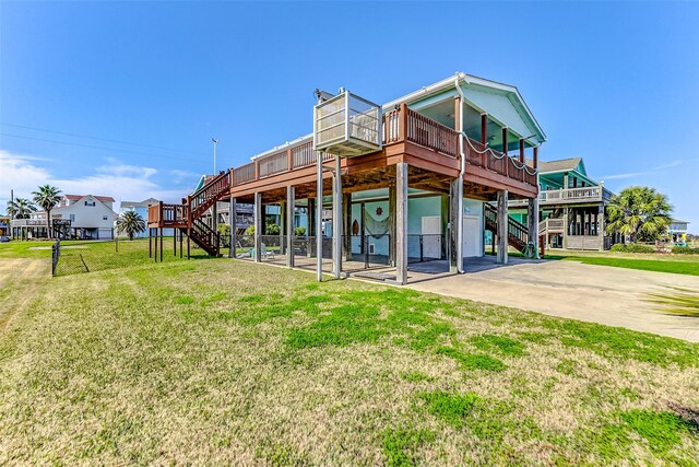 back of house with stairs, a yard, a carport, and a wooden deck