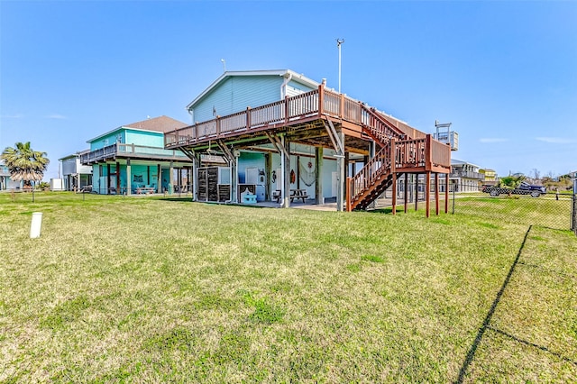 back of house with stairs, fence, a lawn, and a wooden deck