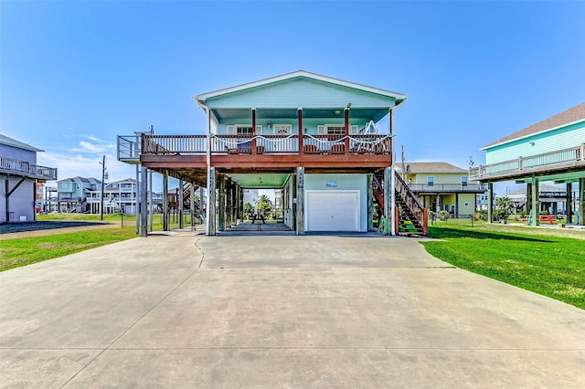 coastal inspired home featuring covered porch, stairway, an attached garage, a front yard, and driveway