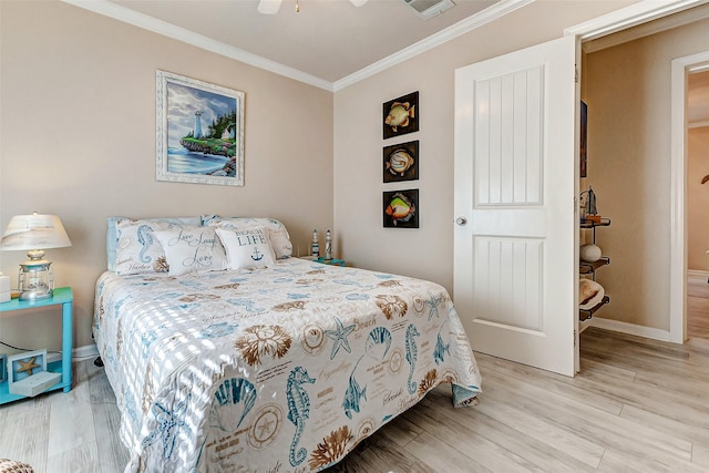 bedroom featuring light wood-style flooring, ornamental molding, and baseboards