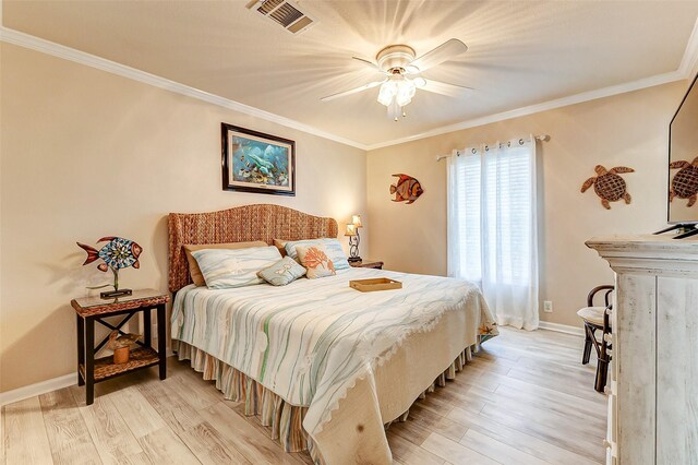 bedroom featuring light wood-style flooring, visible vents, and ornamental molding