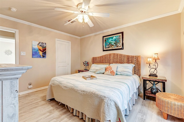 bedroom with light wood finished floors, baseboards, visible vents, a ceiling fan, and ornamental molding