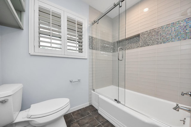 full bath featuring toilet, baseboards, bath / shower combo with glass door, and tile patterned floors