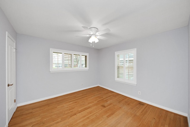 unfurnished room with light wood-style flooring, baseboards, and a ceiling fan