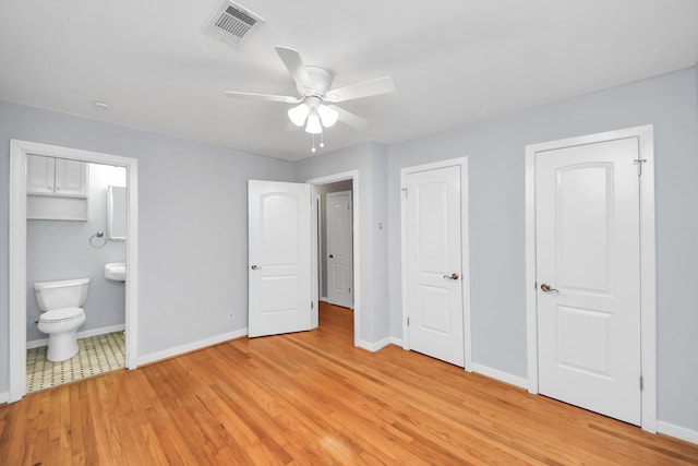 unfurnished bedroom with visible vents, light wood-style flooring, and baseboards