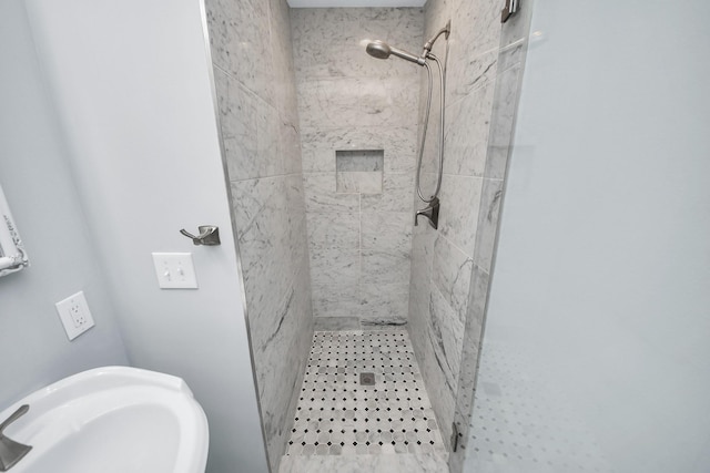 full bath featuring a sink and a shower stall