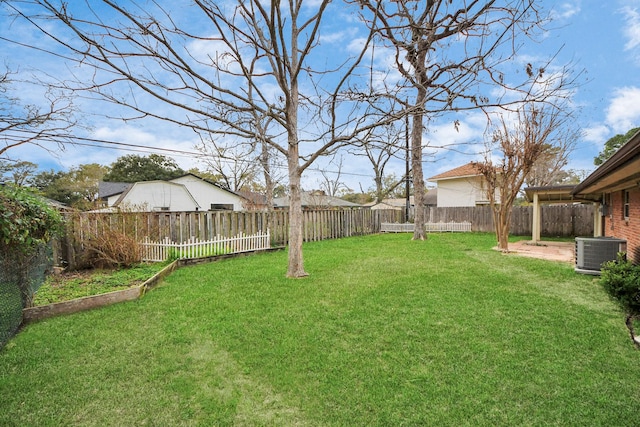 view of yard with central AC and a fenced backyard