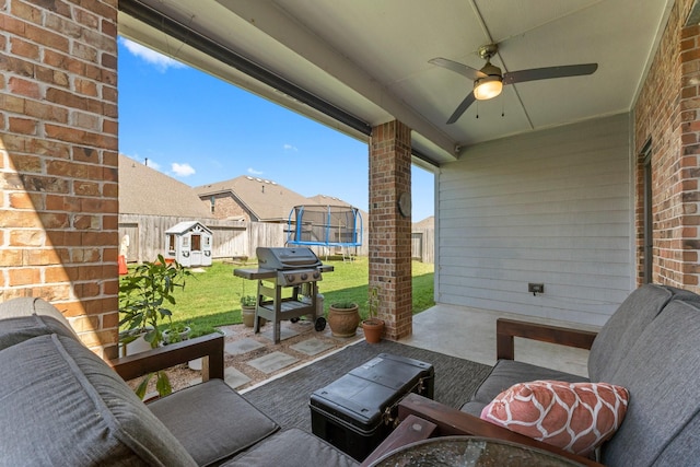 view of patio / terrace with a grill, a trampoline, a ceiling fan, and a fenced backyard