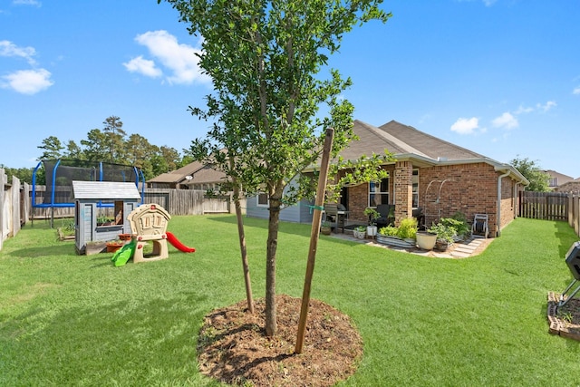 view of yard with a fenced backyard and a trampoline