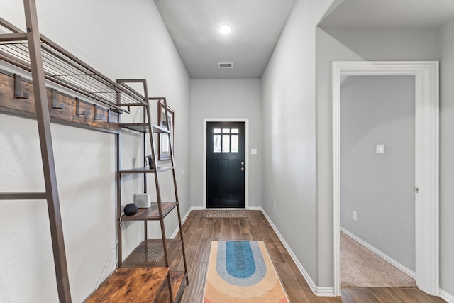 entrance foyer with visible vents, baseboards, and wood finished floors