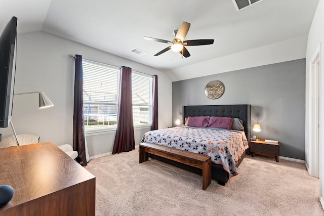 bedroom with light colored carpet, visible vents, vaulted ceiling, and baseboards