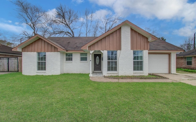 view of front of home with board and batten siding, concrete driveway, brick siding, and a front lawn