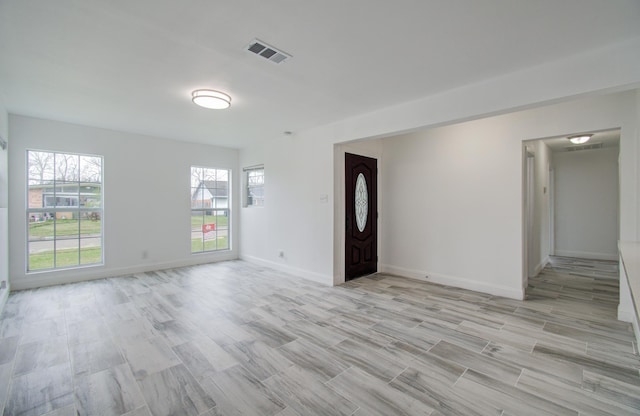 entrance foyer featuring light wood-type flooring, baseboards, and visible vents