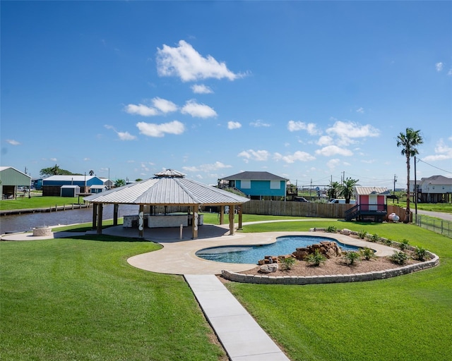 view of pool with a gazebo, a lawn, fence, and a fenced in pool