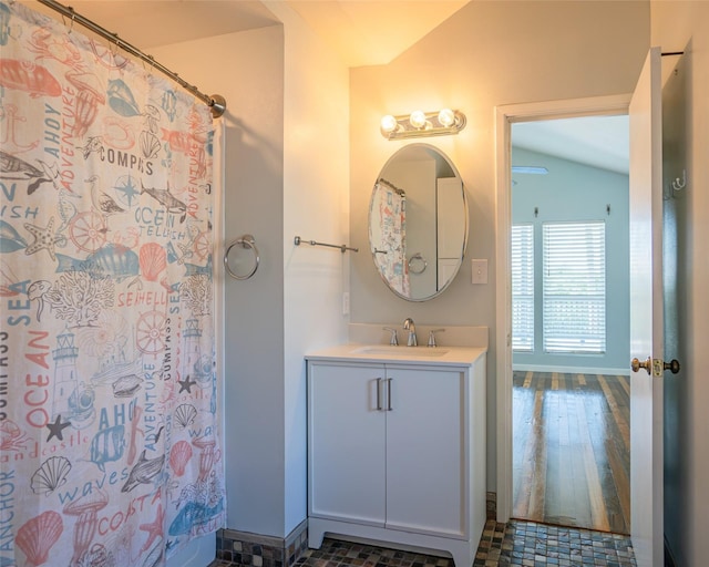 632 County Road 204, Sargent, TX 77414 - bathroom with lofted ceiling, a shower with shower curtain, and vanity