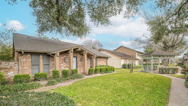 3048 Gessner Rd, Houston, TX 77080 - view of front of property featuring a gazebo, brick siding, a front lawn, and a shingled roof