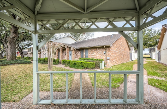 3048 Gessner Rd, Houston, TX 77080 - view of front of property featuring brick siding, a gazebo, a front lawn, and a shingled roof